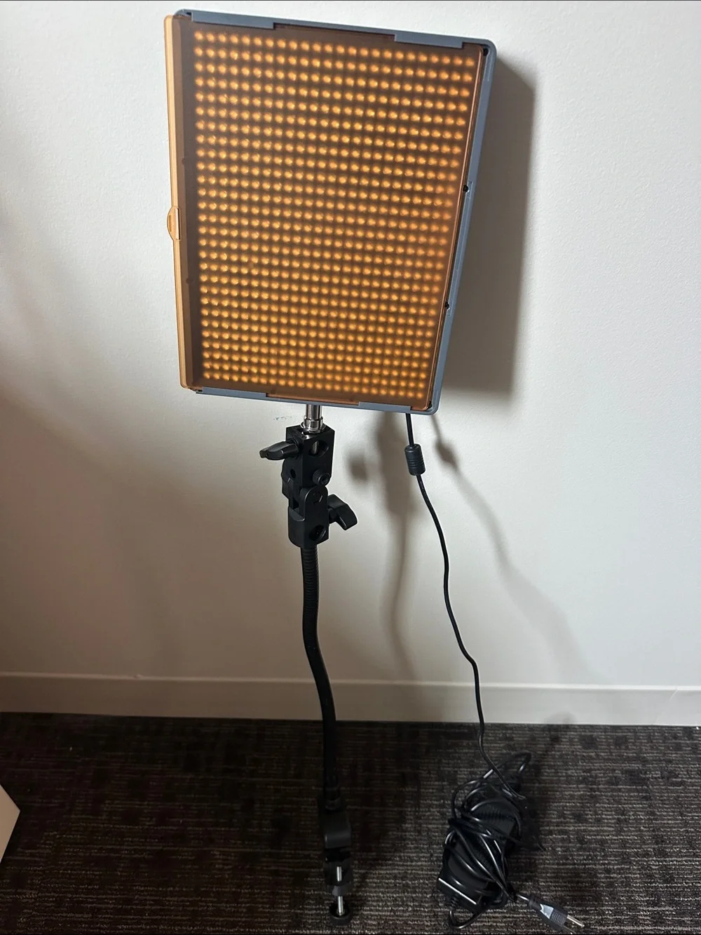 Aputure Amaran HR672W LED Video Light Panel with stand/holder and orange filter.